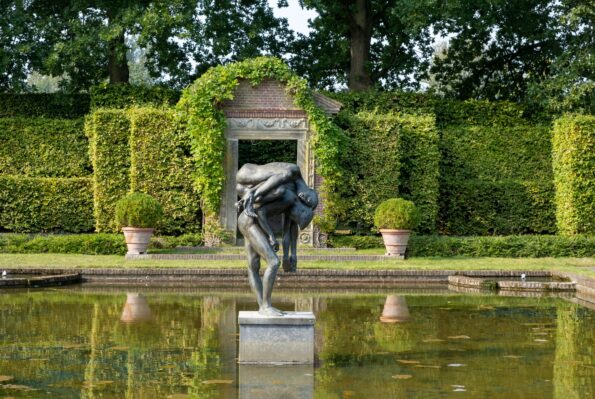 De spiegelvijver met een beeld in de museumtuin